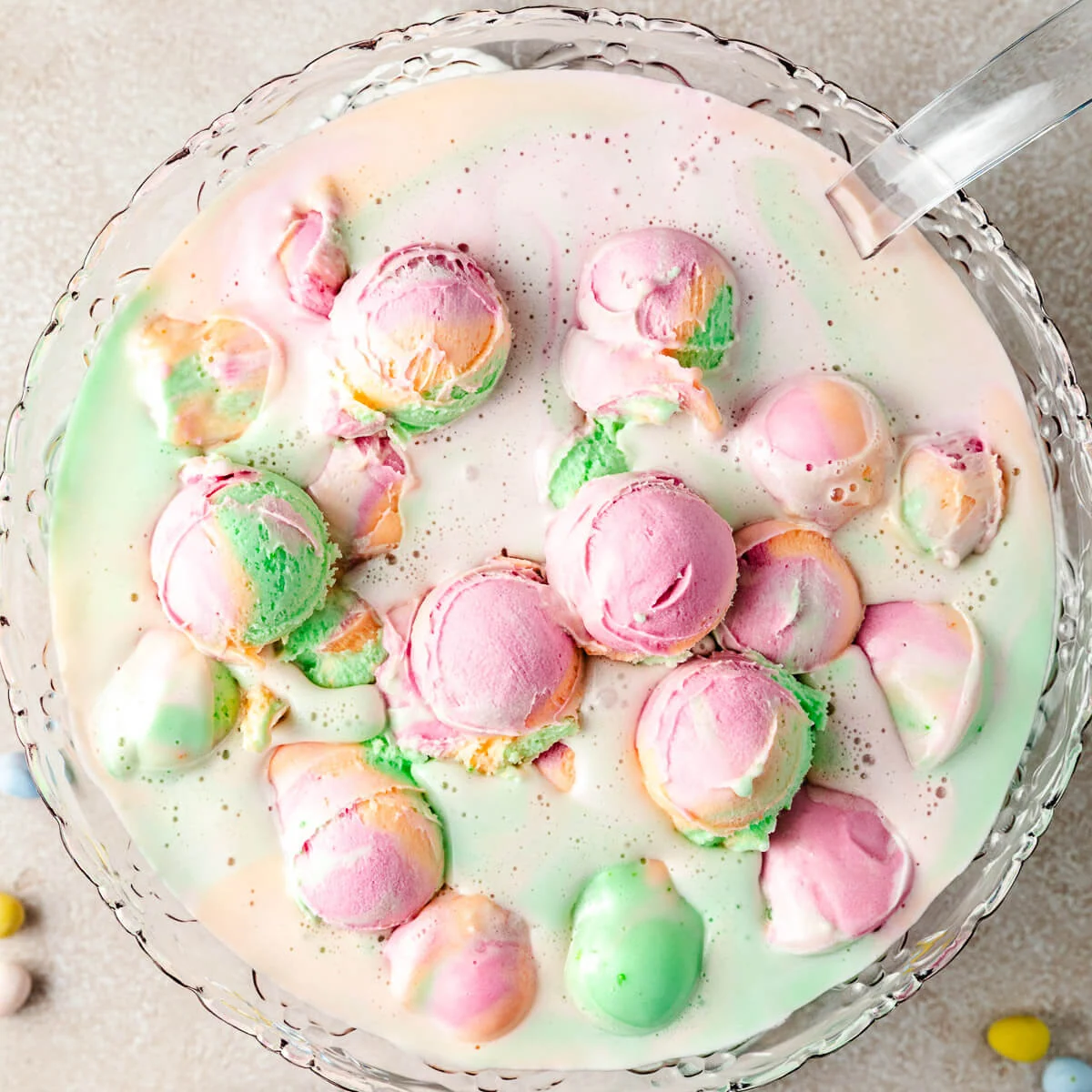 Punch bowl filled with rainbow sherbet punch.