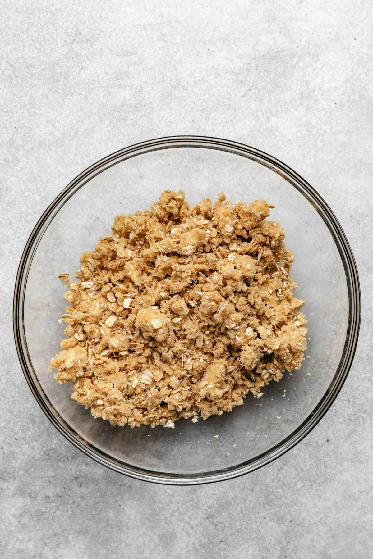 Oat crumble topping mixed in a glass bowl.