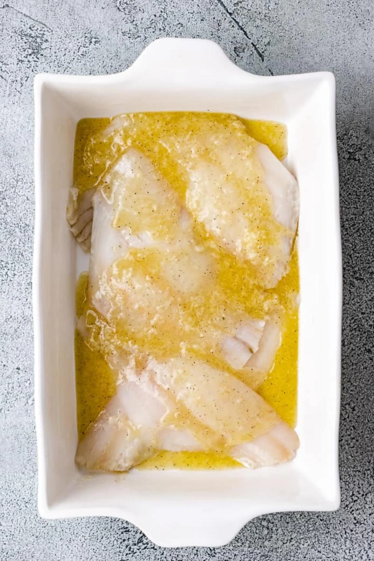 Lemon garlic butter poured over flounded fillets.