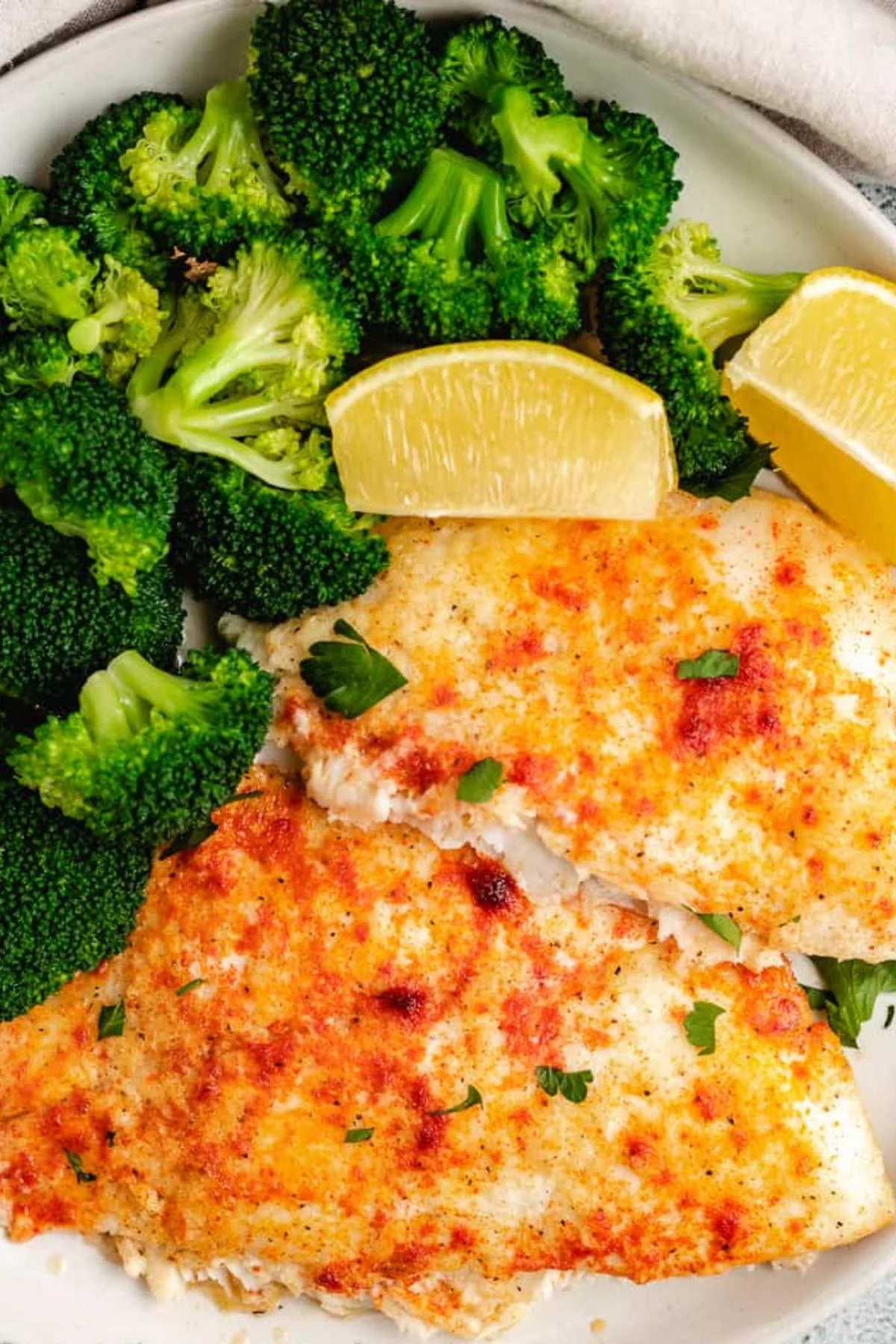 Close up view of baked flounder on a plate.