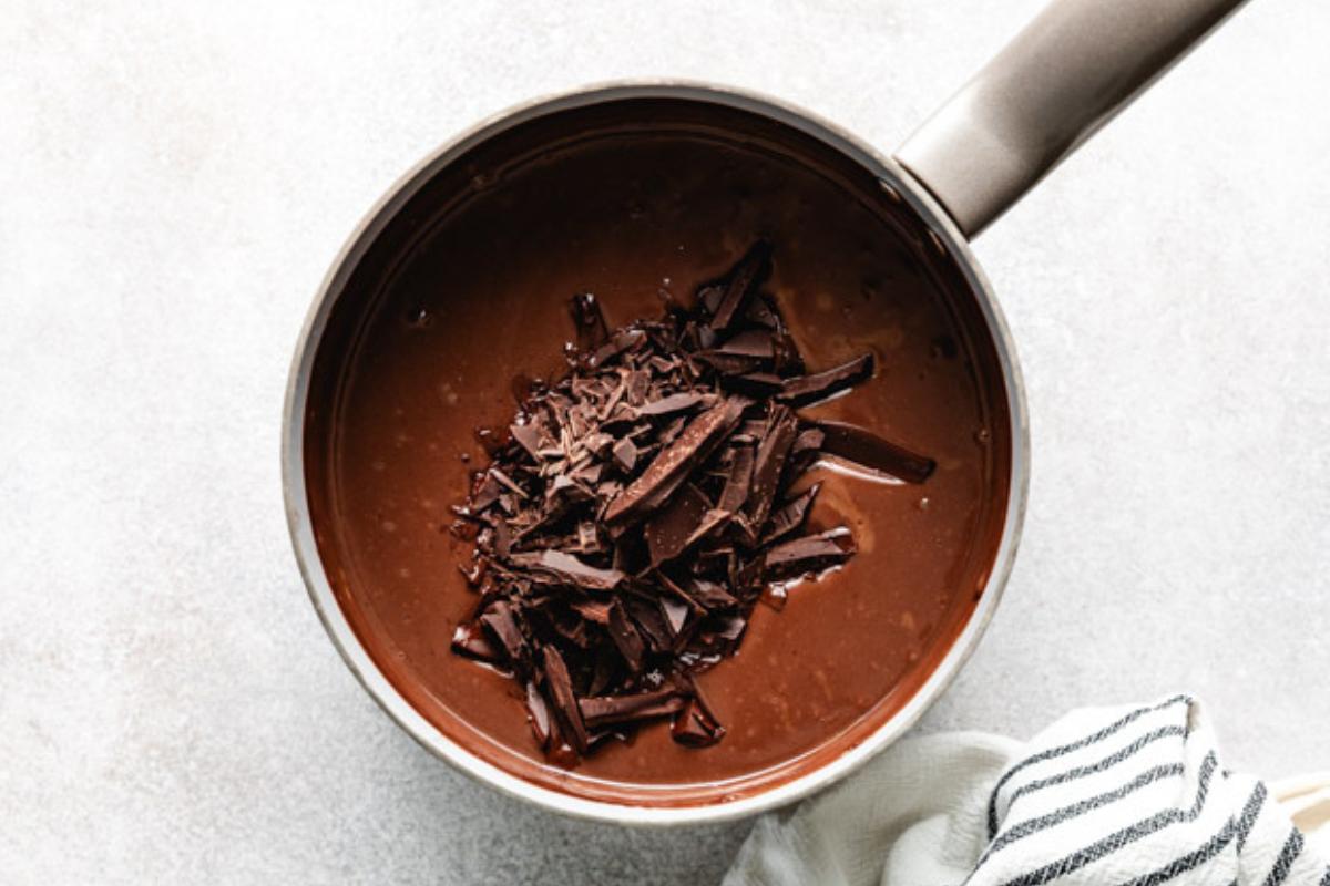 Chocolate shavings added to a pan of chocolate pudding.