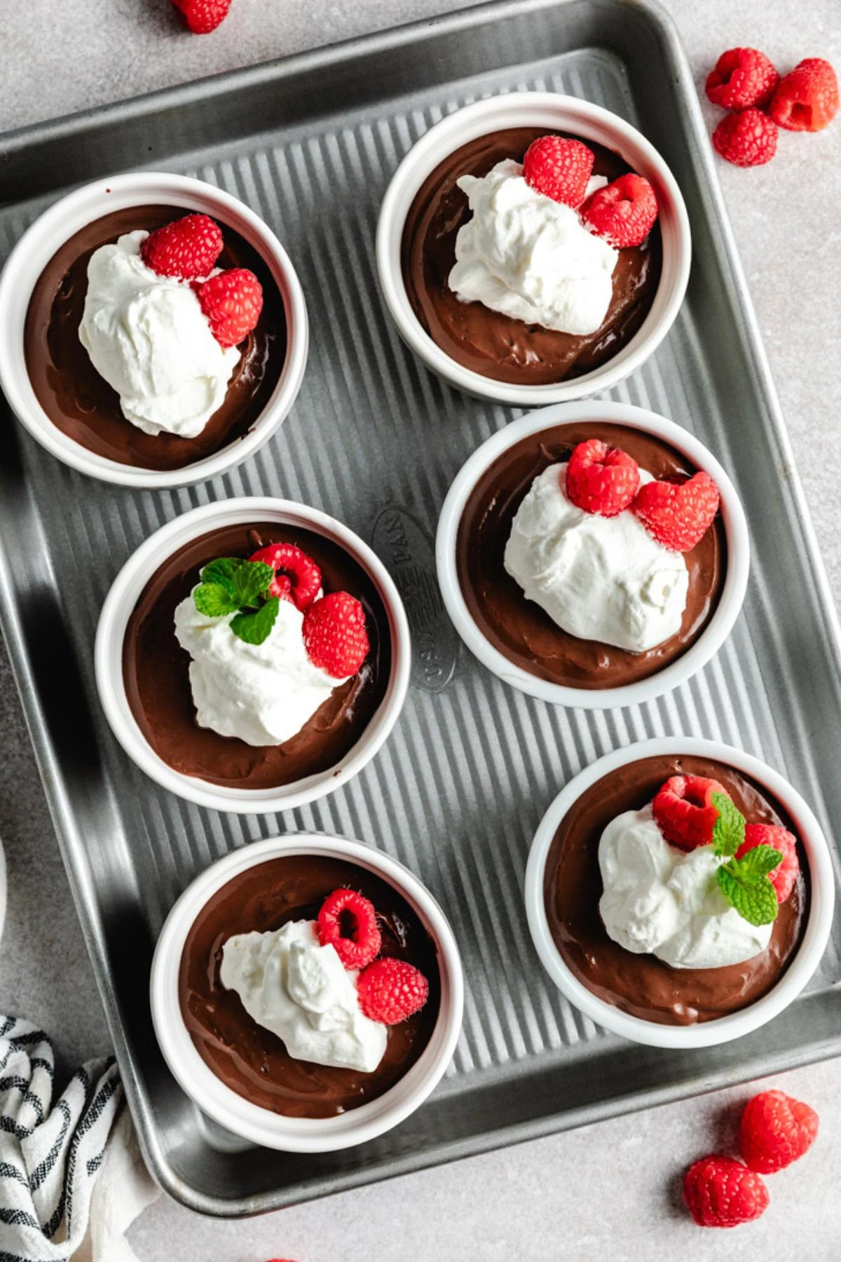 Overhead view of chocolate pudding in ramekins.