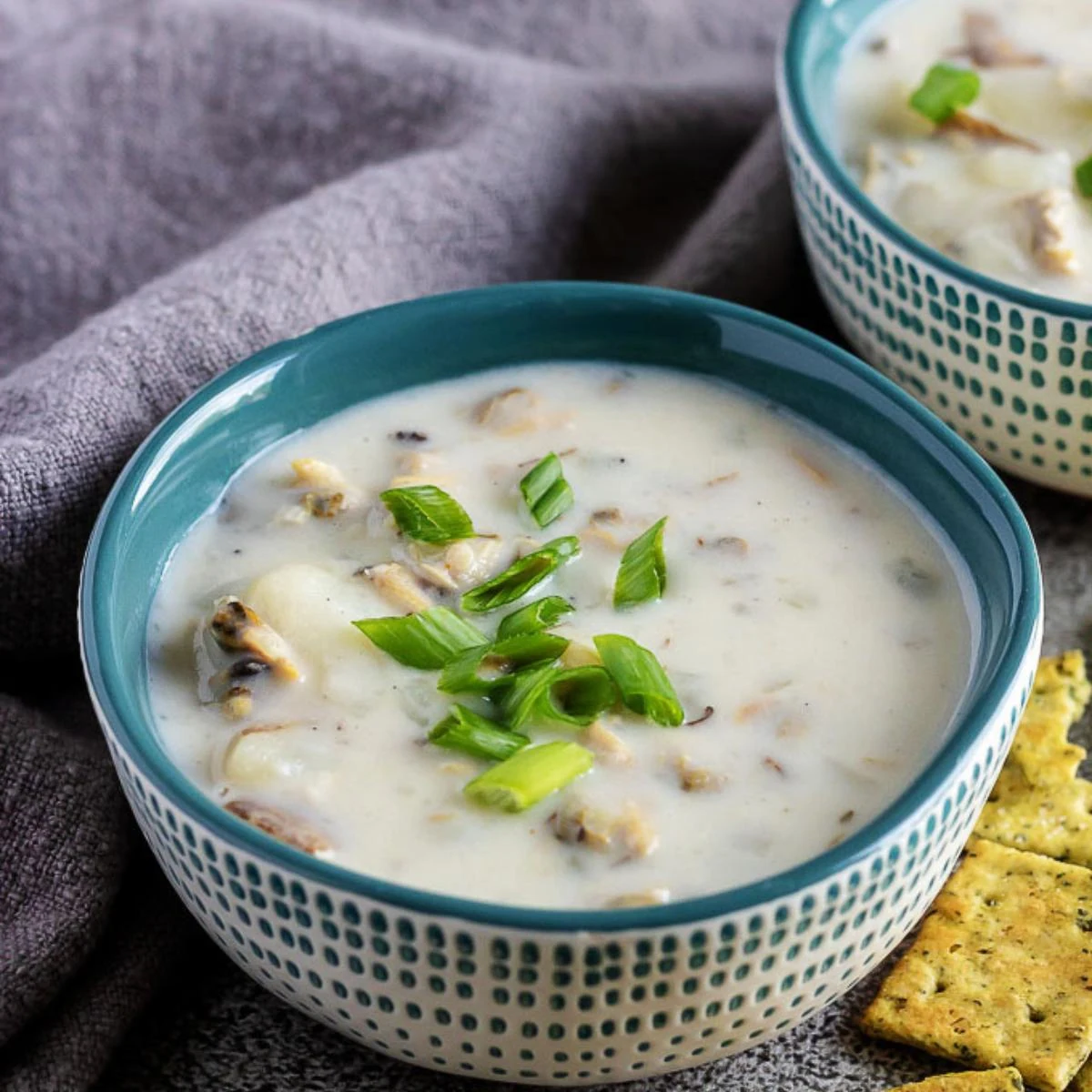 Close up view of bowls of instant pot clam chowder.