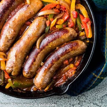 Overhead view of a pan of Italian sausage and pepeprs.