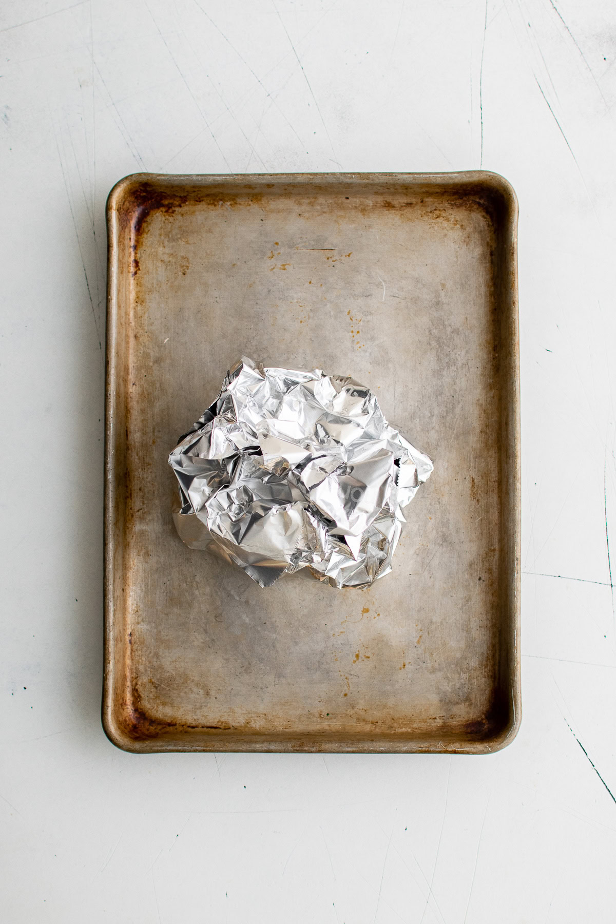 Bulbs of garlic sealed in a packet of foil.