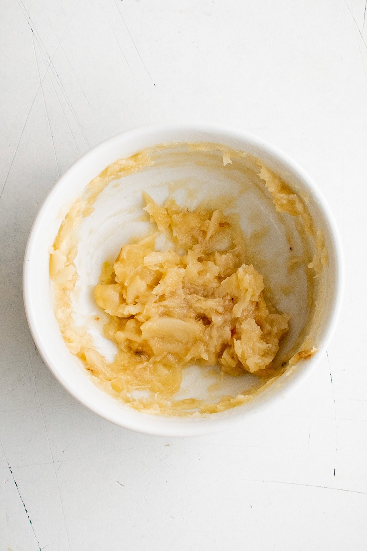 Mashed garlic cloves in a bowl.