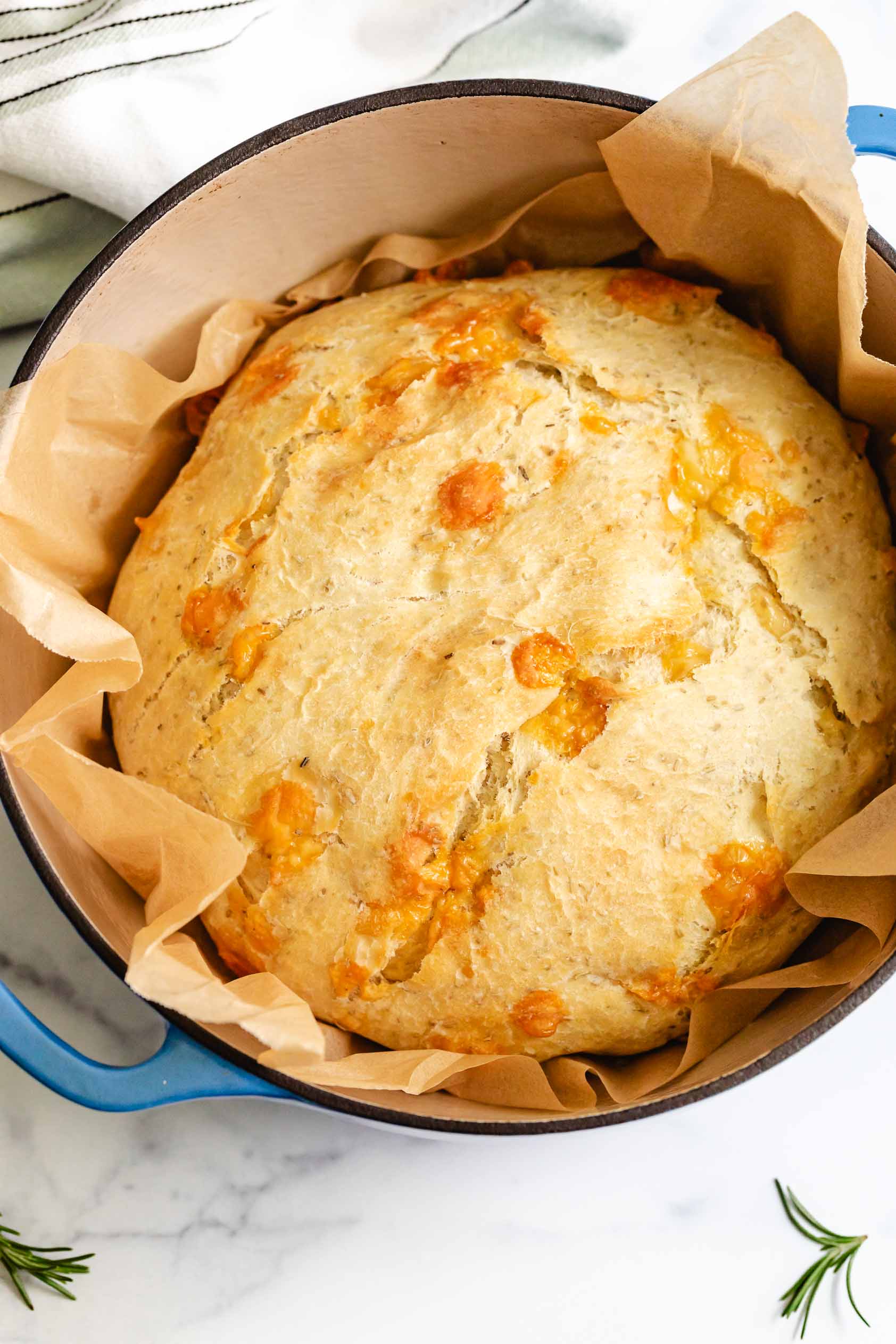 Loaf of rosemary parmesan bread in a pan.